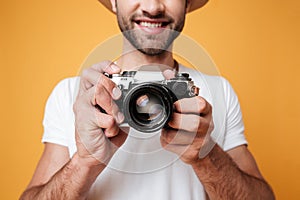 Close up shot of young man taking photo with retro camera