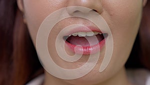 Close up shot of young women moves her lips talking with camera showing white straight healthy teeth, Lower part face detail of