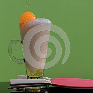 Close-up shots of beer bubbles with ping-pong in glass.