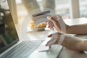 Close up shots hands of person shopping on ecommerce and using credit card payment via online banking