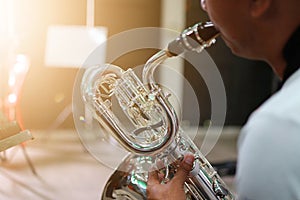Close-up shots of musicians playing  Baritone Saxophone  In the music practice room, blurred background