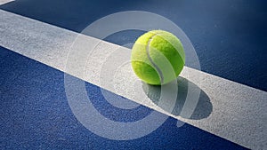 Close-up shots of tennis rackets and tennis balls With light and soft On a tennis court with a beautiful shiny background For maki