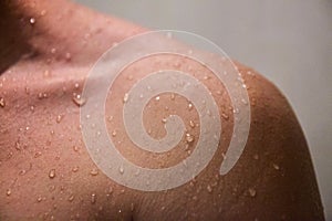 Close up shoulder of man which take a shower.