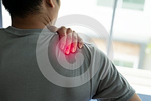 Close-up of shoulder pain from office syndrome, asian man touching neck and shoulders feeling body pain, importance