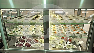 Close-up, showcase with salads in modern canteen, cafeteria, dining room resturant, restaurant of public catering