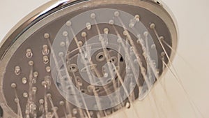 Close up Shower head with Water Drops Splashing out and Running from Faucet in Bathroom Flowing in Slow Motion shot