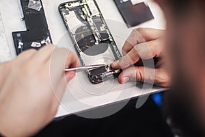 Close-up, showing process of mobile phone repair at service center