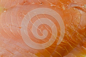 Close-up showing the texture of a slice of smoked salmon.