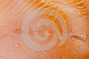 Close-up showing the texture of a slice of smoked salmon.