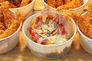 Close up Shrimp tempura with tomato sauce and mayonnaise In a round white paper cup, street food