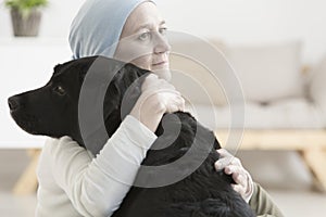 Sick woman hugging dog