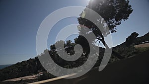 Close up side of car and light on the road. Driving car on the mountain road. Car rides on serpentine. White mountains