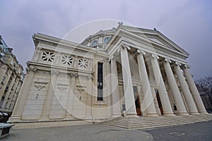 Close up side facade with long large columns pillars of Romanian Athenaeum, a concert hall in the centre of Bucharest, Romania
