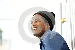 Close up side of handsome young black man smiling and looking away