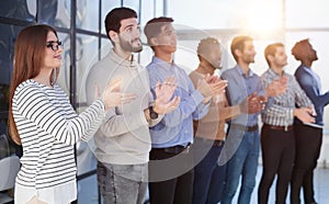 Close up side profile, different participants business people stand and express appreciation by clapping their hands