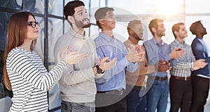 Close up side profile, different participants business people stand and express appreciation by clapping their hands