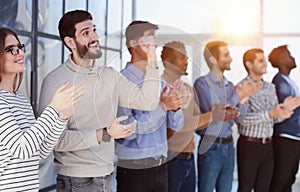 Close up side profile, different participants business people stand and express appreciation by clapping their hands