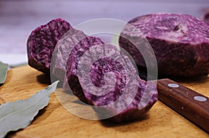 Close-up side view of blue potatoes, which are cut into wavy circles. Fresh vegetables for excellent immunity.