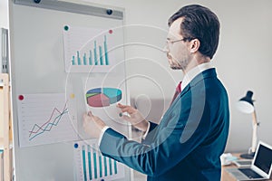 Close up side view of focused businessman putting paper with pie