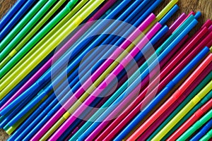 Close up side view of a group of new colored plastic straws.