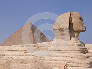 Close up of the Side view of the of the Sphinx statue Giza Egypt with the Great Pyramid in the background.