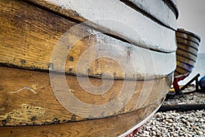 Close up of the side of a wooden fishing boat