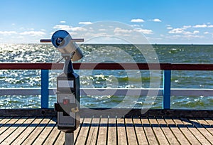 Close-Up of sightseeing monocular with sea background