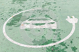 A close-up sign of an electric vehicle cars charging at the station, painted on asphalt. Transport concept.