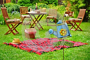 Close-Up Of Sign Welcome And Backyard Party Or Picnic Scene