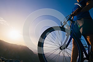 Close up silhouette of an athlete mountain biker riding his bike on rocky mountains