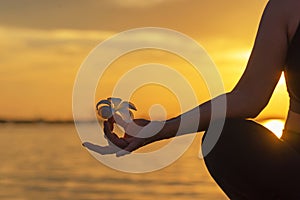 Close up silhouette hands. Woman do yoga outdoor. Woman exercising vital and meditation for fitness lifestyle club at the sunset