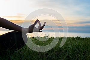 Close up Silhouette hands. Woman do yoga outdoor. Woman exercising vital and meditation for fitness lifestyle club at the sunset b photo