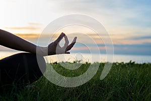 Close up Silhouette hands. Woman do yoga outdoor. Woman exercising vital and meditation for fitness lifestyle club at the sunset b