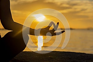 Close up Silhouette hands. Woman do yoga outdoor. Woman exercising vital and meditation for fitness lifestyle club at the sunset b