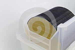 Close up of Silicon wafers gold yellow color with chip cells prepared for production in a semiconductors manufacturing facility