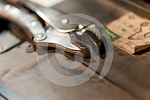 Close-Up of a Silver Adjustable Wrench Resting on a Workshop Table