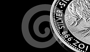 Close up of Silver Bullion Coin on a black mirror background