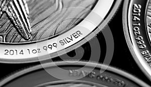 Close up of Silver Bullion Coin on a black mirror background