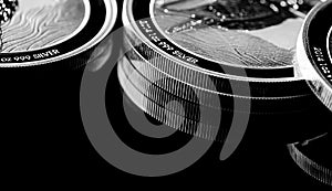 Close up of Silver Bullion Coin on a black mirror background