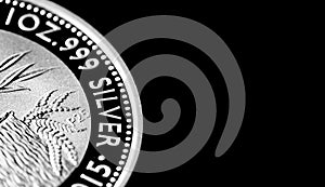 Close up of Silver Bullion Coin on a black mirror background