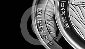 Close up of Silver Bullion Coin on a black mirror background