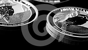 Close up of Silver Bullion Coin on a black mirror background