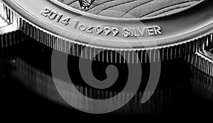 Close up of Silver Bullion Coin on a black mirror background