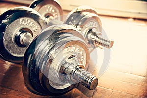 Close up silver dumbbell on floor (retro style)