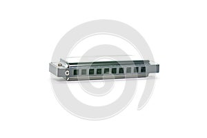 Close-up of a simple metal harmonica in C, isolated on a white background