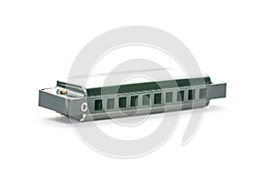 Close-up of a simple metal harmonica in C, isolated on a white background