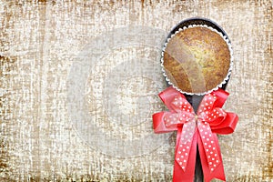 Close up single banana cup cake bakery top view on wood ladle with big red bow look delicious on wooden table background