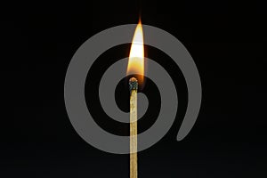 Close up Single matchstick burning isolated on black background