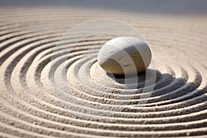 Close up of single stone in Zen garden surrounded by circles