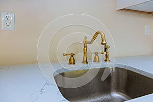 Close up of sinks in modern white kitchen with white stone